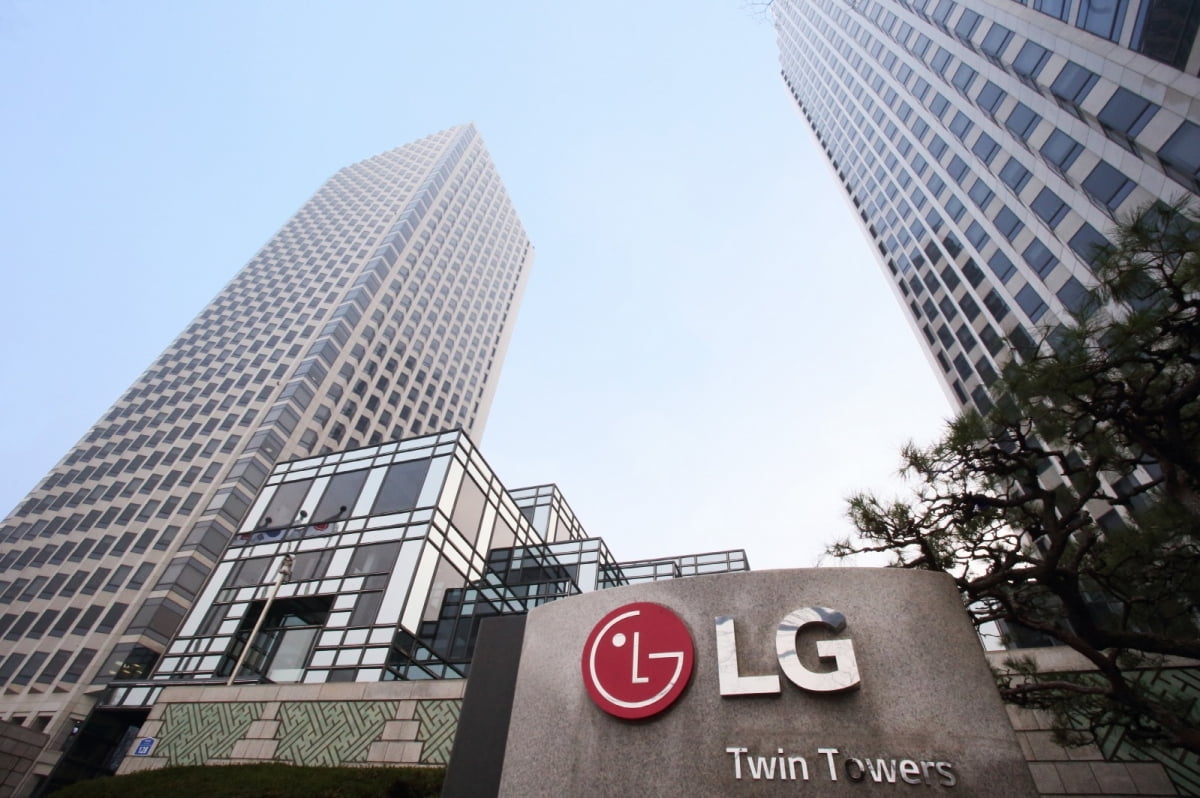 a sign with a logo in front of a building